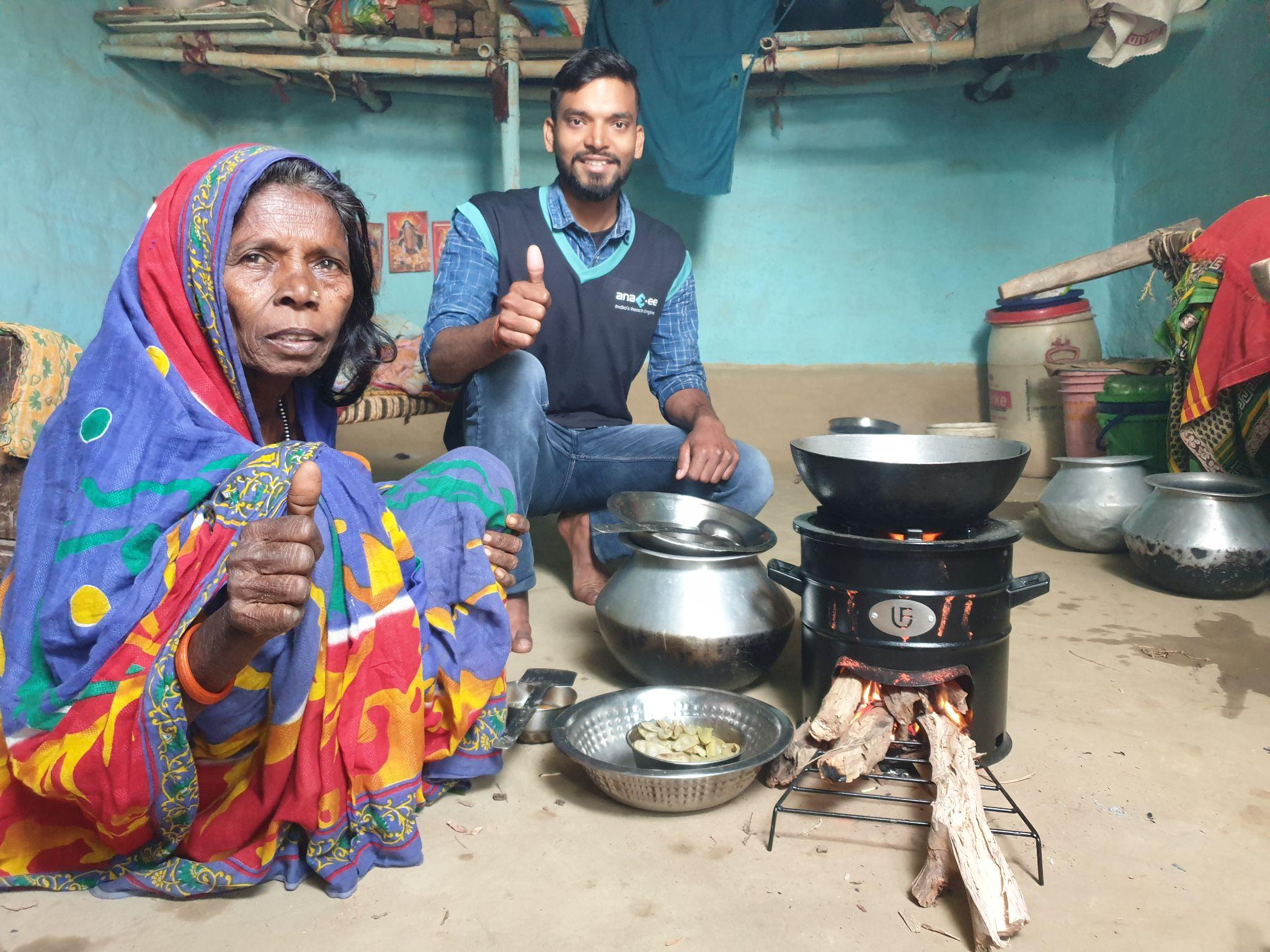 Beneficiary and Digital Runner showing thumbs up after Receiving Improved Cookstove under Anaxee's Clean Cooking Initiative